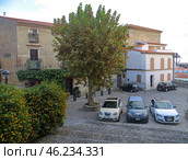 Scalea, Italy. November 20, 2024. Calabria. Scalea old city, historical center.A small square with parked cars at sunset. Редакционное фото, фотограф Мария Фетисова / Фотобанк Лори