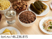 Lenten dishes against a wooden background remind of the light of a post that illuminates the path to God through prayer and abstinence. Стоковое фото, фотограф Скрипачев Антон / Фотобанк Лори