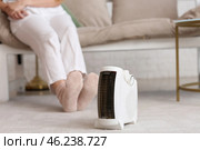 Modern electric fan heater on carpet in living room, closeup. Стоковое фото, фотограф Pixel_shot / Фотобанк Лори