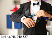 Cute little magician showing trick indoors, closeup. Стоковое фото, фотограф Pixel_shot / Фотобанк Лори