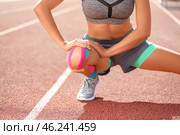 Sporty woman with physio tape stretching at stadium. Стоковое фото, фотограф Pixel_shot / Фотобанк Лори