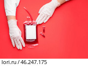 Hands of doctor with blood pack for transfusion and test tubes on color background. Стоковое фото, фотограф Pixel_shot / Фотобанк Лори
