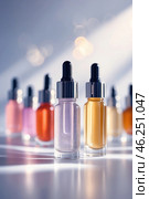 Variety of colorful cosmetic serums arranged with an artistic backdrop highlighting their elegant design and shimmering textures. Стоковое AI-изображение, AI-художник Сергей Толмачёв / Фотобанк Лори