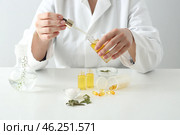 Doctor with natural essential oil at table. Стоковое фото, фотограф Pixel_shot / Фотобанк Лори