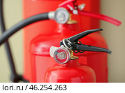 Fire extinguishers on color background, closeup. Стоковое фото, фотограф Pixel_shot / Фотобанк Лори