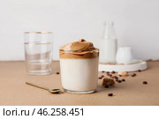 Glass of tasty dalgona coffee on table. Стоковое фото, фотограф Pixel_shot / Фотобанк Лори