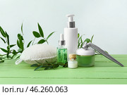 Cosmetics with bast wisp and massage tool on wooden table. Стоковое фото, фотограф Pixel_shot / Фотобанк Лори
