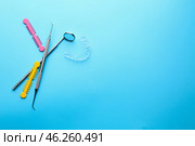 Dental instruments and occlusal splint on color background. Стоковое фото, фотограф Pixel_shot / Фотобанк Лори