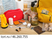 Necessities for emergency bag on wooden table. Стоковое фото, фотограф Pixel_shot / Фотобанк Лори