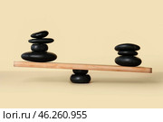 Spa stones on teeterboard against light background. Concept of balance. Стоковое фото, фотограф Pixel_shot / Фотобанк Лори