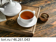 Composition with cup of tasty hojicha green tea on wooden background. Стоковое фото, фотограф Pixel_shot / Фотобанк Лори