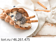 Plate with delicious sweet bubble waffle on table. Стоковое фото, фотограф Pixel_shot / Фотобанк Лори