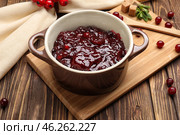 Pot with tasty cranberry sauce on table. Стоковое фото, фотограф Pixel_shot / Фотобанк Лори