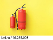 Fire extinguishers on color background. Стоковое фото, фотограф Pixel_shot / Фотобанк Лори
