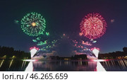 A stunning display of colorful fireworks reflecting on a calm lake under a dark night sky, with green and red explosions lighting up the water and creating a mesmerizing celebration scene. Стоковое AI-видео, аниматор Башкирова Анна / Фотобанк Лори