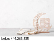 Decorative crescent, hat and Muslim prayer beads on light background. Стоковое фото, фотограф Pixel_shot / Фотобанк Лори