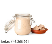 Jar with fresh sourdough and yeast on white background. Стоковое фото, фотограф Pixel_shot / Фотобанк Лори
