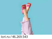 Legs of young woman in jeans and pink open-toed high heels on blue background. Стоковое фото, фотограф Pixel_shot / Фотобанк Лори