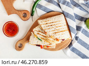 Board with tasty vegetarian quesadillas and sauce on white background. Стоковое фото, фотограф Pixel_shot / Фотобанк Лори