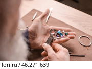 Jeweller examining gemstones in workshop, closeup. Стоковое фото, фотограф Pixel_shot / Фотобанк Лори