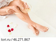 Beautiful young woman epilating legs indoors. Стоковое фото, фотограф Pixel_shot / Фотобанк Лори