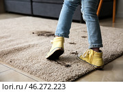 Little girl in muddy shoes messing up carpet at home. Стоковое фото, фотограф Pixel_shot / Фотобанк Лори