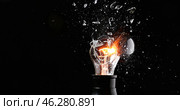 Breaking of light bulb on dark background. Стоковое фото, фотограф Pixel_shot / Фотобанк Лори