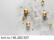 Composition with champagne glass, Christmas decorations and glitters on white background. Стоковое фото, фотограф Pixel_shot / Фотобанк Лори