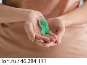 Woman with green ribbon, closeup. Mitochondrial diseases and kidney cancer concept. Стоковое фото, фотограф Pixel_shot / Фотобанк Лори