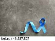 Blue ribbon on grey background. Prostate cancer concept. Стоковое фото, фотограф Pixel_shot / Фотобанк Лори