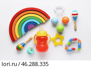 Educational toys blocks, rattles and baby bottle on white background. Стоковое фото, фотограф Pixel_shot / Фотобанк Лори