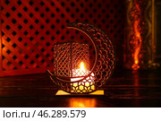 Arabic candle holder with glowing candle on dark background. Стоковое фото, фотограф Pixel_shot / Фотобанк Лори