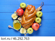 Honey with fruits and challah on color wooden background. Rosh hashanah (Jewish New Year) celebration. Стоковое фото, фотограф Pixel_shot / Фотобанк Лори