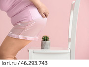 Elderly woman and chair with cactus on color background. Hemorrhoids concept. Стоковое фото, фотограф Pixel_shot / Фотобанк Лори