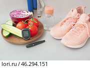 Vegetables, sports shoes, lancet pen and glucometer on grey background. Diabetes concept. Стоковое фото, фотограф Pixel_shot / Фотобанк Лори