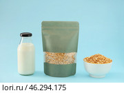 Bag with oat groat and bottle of milk on color background. Стоковое фото, фотограф Pixel_shot / Фотобанк Лори