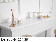 Mantelpiece with candle holders in stylish interior of room. Стоковое фото, фотограф Pixel_shot / Фотобанк Лори