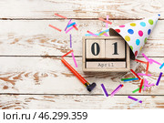 Party decor and calendar with date of April Fools Day on white wooden background. Стоковое фото, фотограф Pixel_shot / Фотобанк Лори