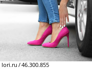 Young woman with pain in legs because of uncomfortable shoes sitting in car. Стоковое фото, фотограф Pixel_shot / Фотобанк Лори