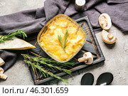 Baking dish with tasty julienne and ingredients on grey background. Стоковое фото, фотограф Pixel_shot / Фотобанк Лори