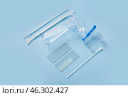 Gynecological speculum with pap smear test tools on blue background. Стоковое фото, фотограф Pixel_shot / Фотобанк Лори