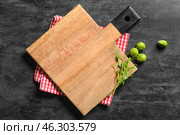 Wooden cutting board with micro green, Brussel sprouts and napkin on dark background. Стоковое фото, фотограф Pixel_shot / Фотобанк Лори