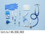 Gynecological speculum with stethoscope, pregnancy test and medical tools on blue background. Стоковое фото, фотограф Pixel_shot / Фотобанк Лори