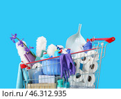 Shopping cart full of cleaning supplies and purple flowers on blue background. Стоковое фото, фотограф Pixel_shot / Фотобанк Лори