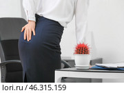 Young businesswoman with hemorrhoids in office. Стоковое фото, фотограф Pixel_shot / Фотобанк Лори