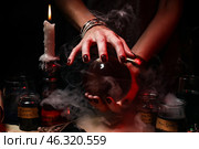 Witch with crystal ball on dark background. Стоковое фото, фотограф Pixel_shot / Фотобанк Лори