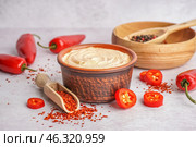 Bowl of tasty chipotle sauce and spices on light background. Стоковое фото, фотограф Pixel_shot / Фотобанк Лори