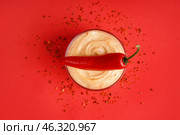 Bowl of tasty chipotle sauce and fresh jalapeno pepper on red background. Стоковое фото, фотограф Pixel_shot / Фотобанк Лори