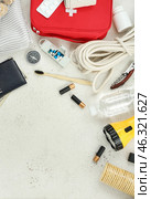 Frame made of necessities for emergency bag on white table. Стоковое фото, фотограф Pixel_shot / Фотобанк Лори