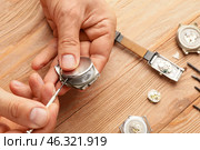 Clockmaker repairing broken watch at table, closeup. Стоковое фото, фотограф Pixel_shot / Фотобанк Лори